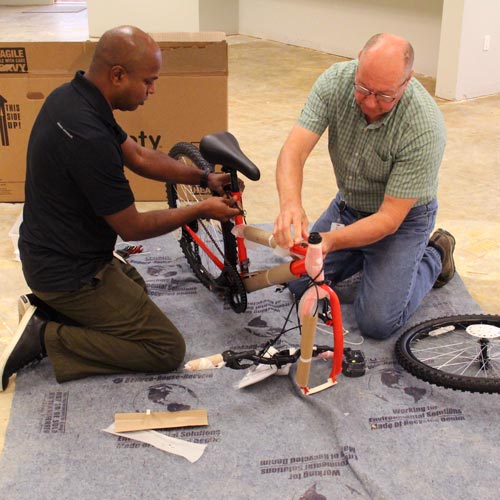 employees assemble bikes at a volunteer event